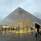 Visitors walk past Le Louvre Lens Museum.